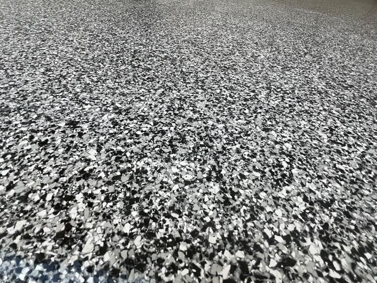 Close view of a black, white, and gray decorative flake floor