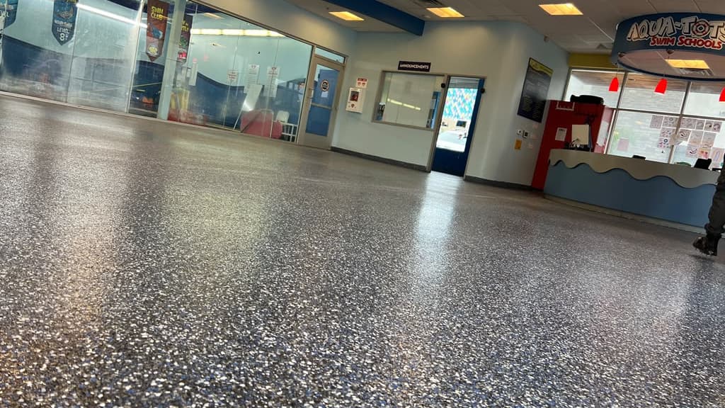 Completed flake epoxy floor extending through a commercial customer area