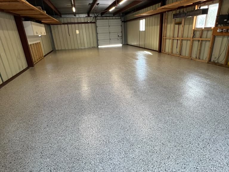 Completed light flake floor across a large open service building