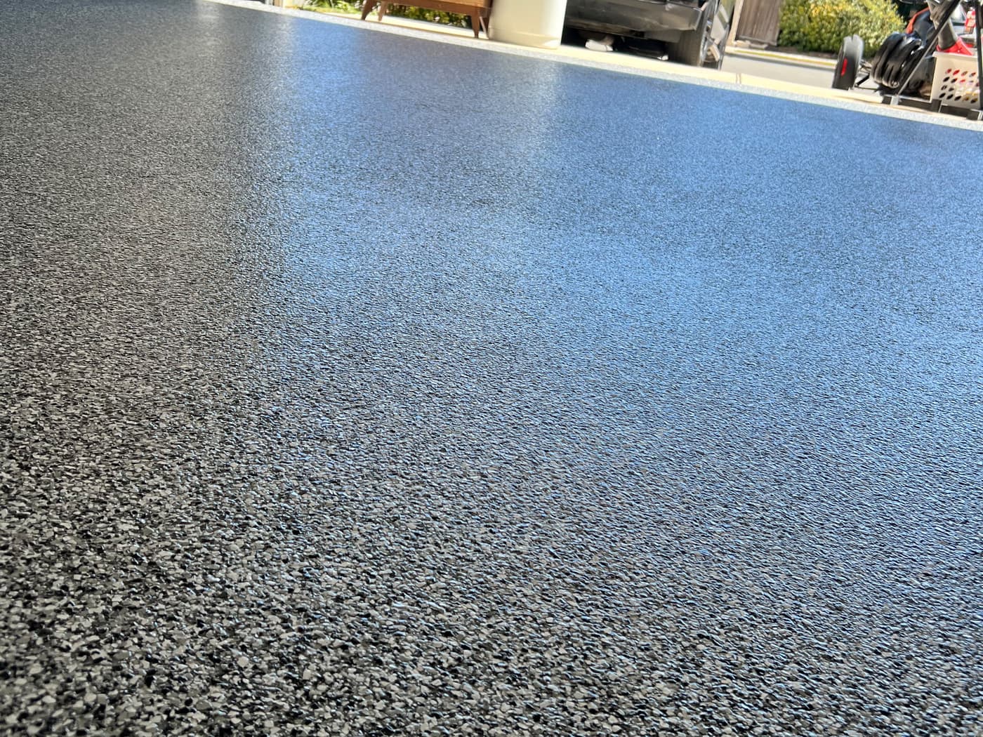 Close view of a completed dark gray textured exterior concrete coating
