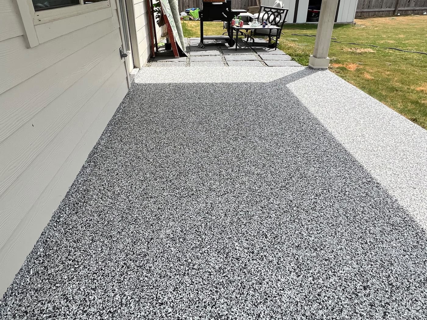 Covered outdoor patio with a completed decorative flake floor