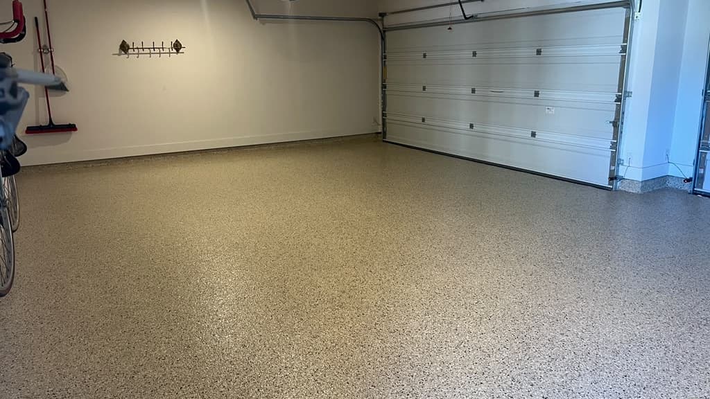 Completed garage with an even gray decorative flake floor