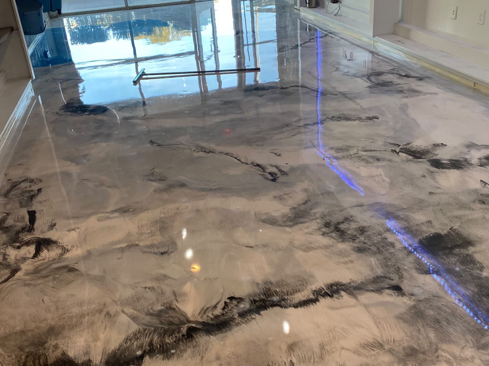 Reflective gray and charcoal metallic floor across a finished interior