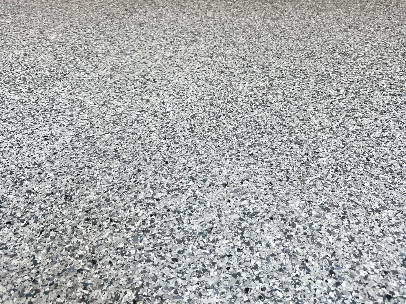 Close view of a completed gray decorative flake garage floor