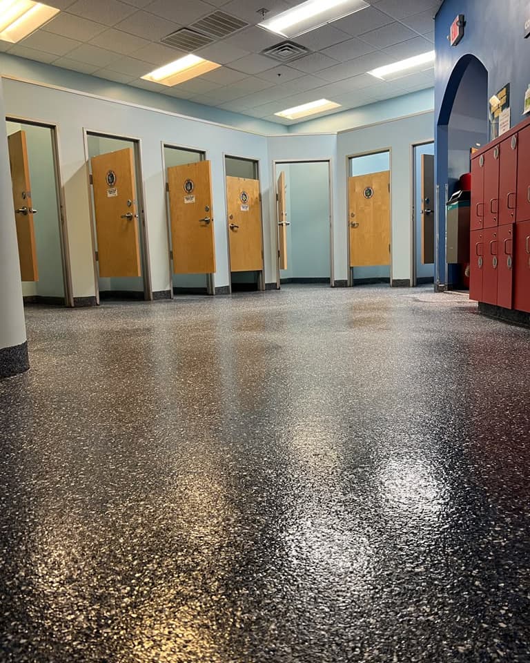 Completed reflective flake epoxy floor in a commercial swim-school interior