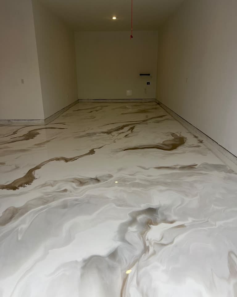 Black and white metallic epoxy floor in a finished residential garage
