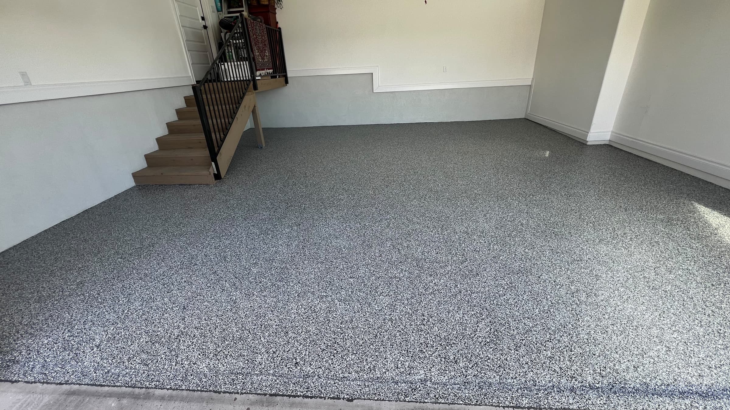 Completed gray Flake epoxy floor across a finished residential garage