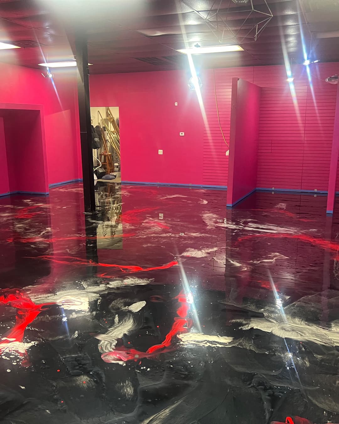 Red, black, and silver metallic floor in a completed interior