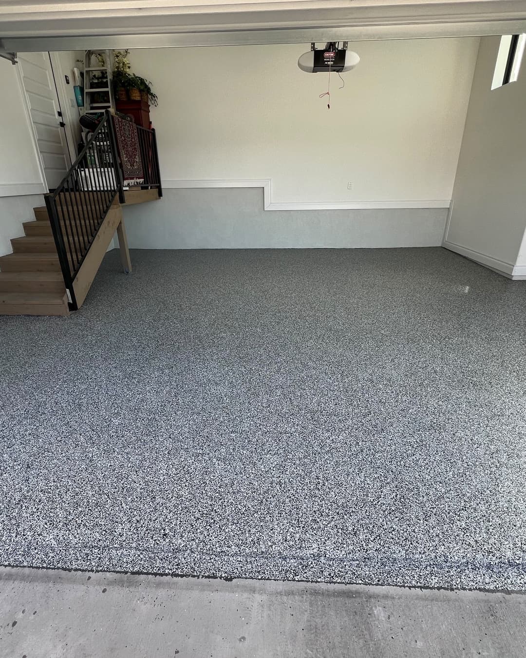 Completed gray flake epoxy floor across a residential garage