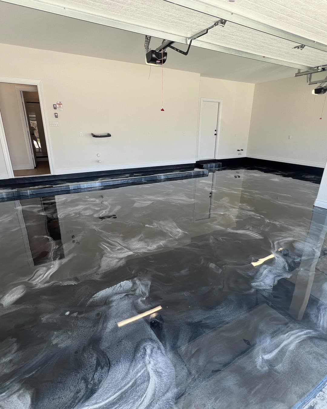 Reflective metallic epoxy floor in a finished residential garage