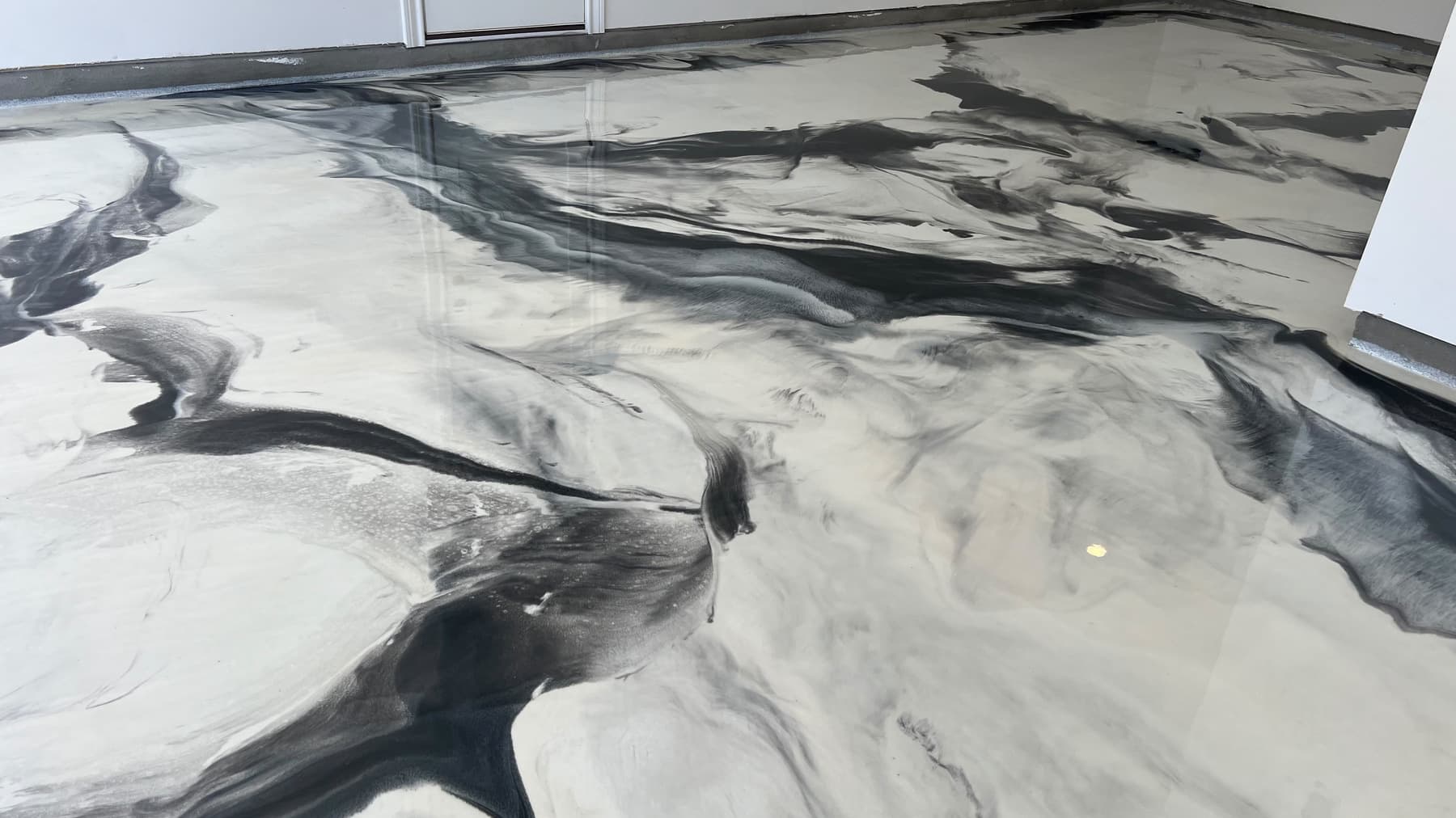 Wide view of a completed white and charcoal Metallic epoxy floor