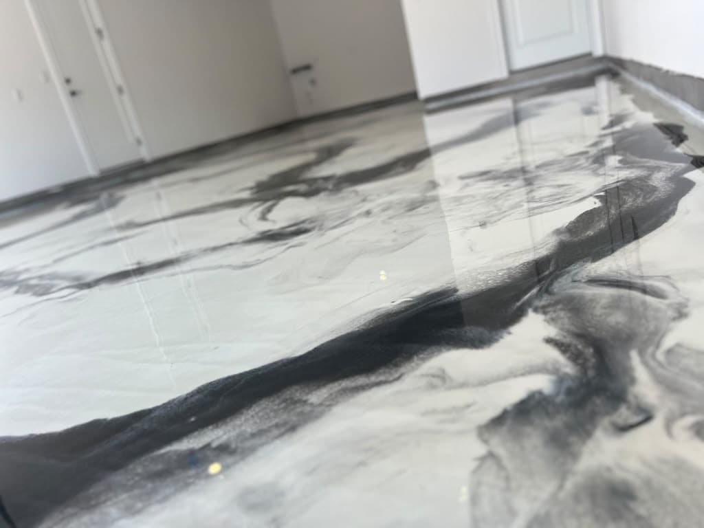 Close view of a completed white and charcoal Metallic epoxy floor