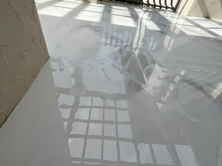 Completed light reflective coating across a covered exterior patio area