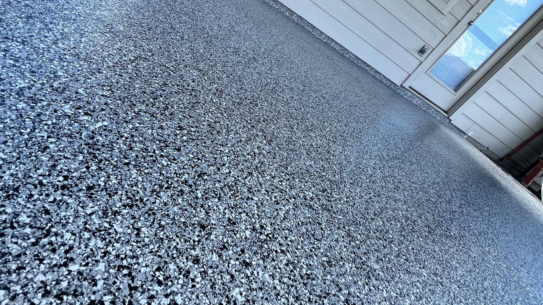 Covered patio with a reflective gray metallic floor