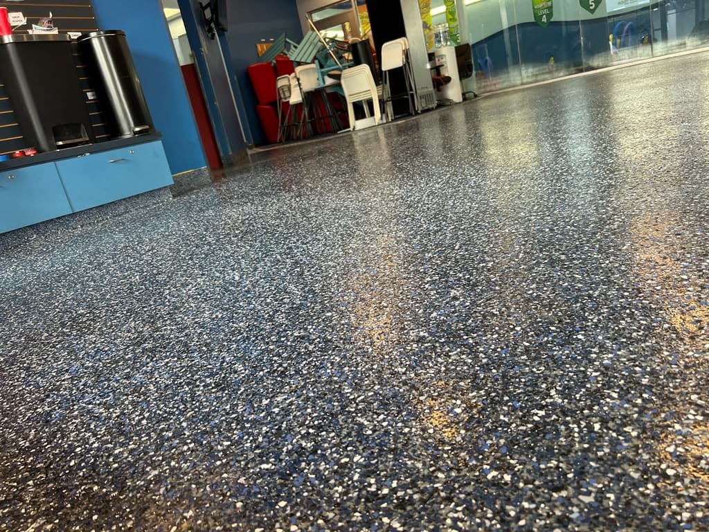 Completed gray flake flooring in a large commercial interior