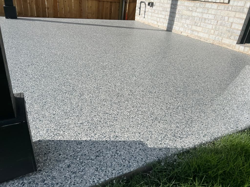 Finished gray flake coating across an outdoor patio